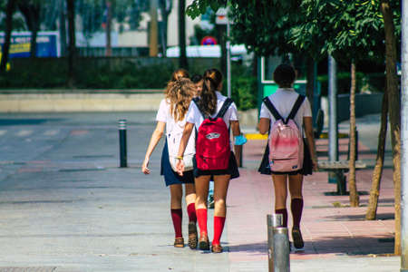 Seville Spain September 22, 2021 School girl walking in the street during the coronavirus outbreak hitting Spain, wearing a mask is not mandatory but most people wear itのeditorial素材