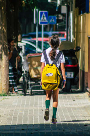 Seville Spain September 22, 2021 School girl walking in the street during the coronavirus outbreak hitting Spain, wearing a mask is not mandatory but most people wear itのeditorial素材