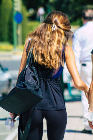 Seville Spain September 22, 2021 Unidentified woman walking in the street during the coronavirus outbreak hitting Spain, wearing a mask is not mandatory but most people wear itのeditorial素材