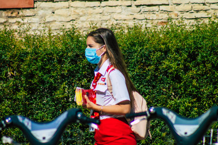 Seville Spain September 22, 2021 Young woman working like a guide tour with tourists in the street during the coronavirus outbreak hitting Spainのeditorial素材