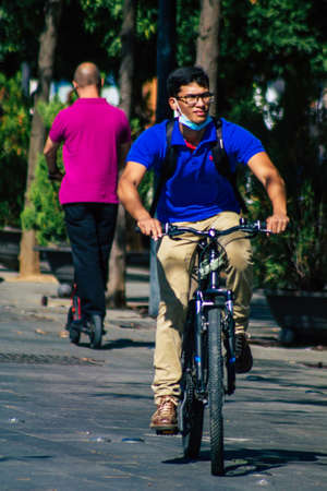 Seville Spain September 22, 2021 People rolling with a bicycle in the streets of Seville, an...