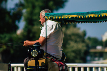 Seville Spain September 22, 2021 Horse drawn carriage ride through the streets of Seville during the coronavirus outbreak hitting Spain, wearing a mask is mandatoryのeditorial素材
