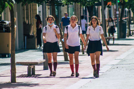 Seville Spain September 22, 2021 School girl walking in the street during the coronavirus outbreak hitting Spain, wearing a mask is not mandatory but most people wear itのeditorial素材