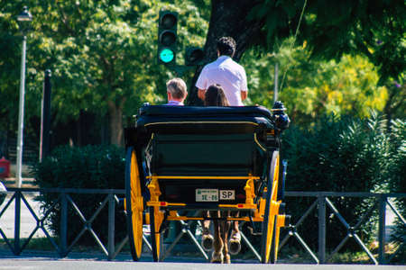 Seville Spain September 22, 2021 Horse drawn carriage ride through the streets of Seville during the coronavirus outbreak hitting Spain, wearing a mask is mandatoryのeditorial素材