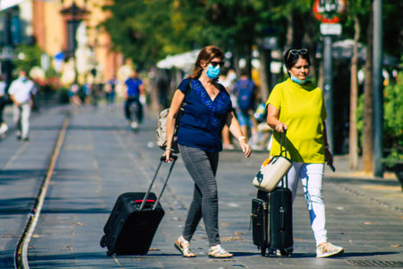 Seville Spain September 22, 2021 Pedestrians walking in the street during the coronavirus outbreak hitting Spain, wearing a mask is not mandatory but most people wear itのeditorial素材