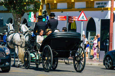 Seville Spain September 18, 2021 Horse drawn carriage ride through the streets of Seville during the coronavirus outbreak hitting Spain, wearing a mask is mandatoryのeditorial素材