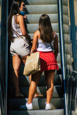 Seville Spain September 18, 2021 Pedestrians using an escalator during the coronavirus outbreak hitting Spain, wearing a mask is not mandatory but most of people wear itのeditorial素材