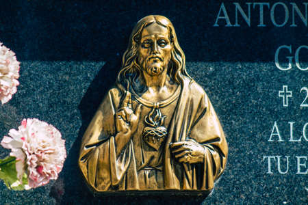 Seville Spain September 21, 2021 Typical graves in a Christian cemetery of the municipality of Carmona in Andalusia in southern Spain, the graves are made in the depth of a wall and richly decoratedのeditorial素材