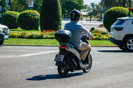 Seville Spain September 22, 2021 People rolling with a motorcycle in the streets of Seville, an emblematic city and the capital of the region of Andalusia, in the south of Spainのeditorial素材