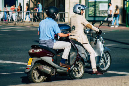Seville Spain September 22, 2021 People rolling with a motorcycle in the streets of Seville, an emblematic city and the capital of the region of Andalusia, in the south of Spainのeditorial素材