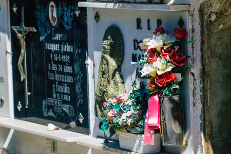 Seville Spain September 21, 2021 Typical graves in a Christian cemetery of the municipality of Carmona in Andalusia in southern Spain, the graves are made in the depth of a wall and richly decoratedのeditorial素材
