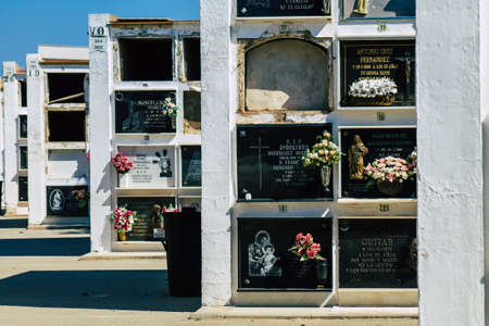Seville Spain September 21, 2021 Typical graves in a Christian cemetery of the municipality of Carmona in Andalusia in southern Spain, the graves are made in the depth of a wall and richly decoratedのeditorial素材