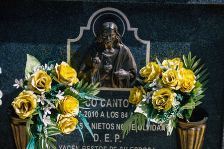 Seville Spain September 21, 2021 Typical graves in a Christian cemetery of the municipality of Carmona in Andalusia in southern Spain, the graves are made in the depth of a wall and richly decoratedのeditorial素材