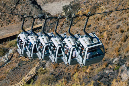 Santorini Island, Fira, Greece - October 08, 2021 Cable car provides a safe transport from the old...