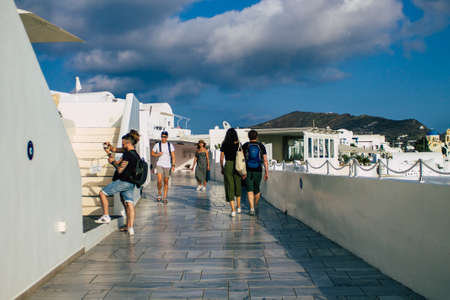 Santorini, Oia, Greece - October 24, 2021 Crowd of tourists visiting the famous perched town of Oia...