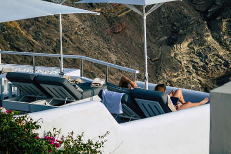 Santorini, Oia, Greece - October 24, 2021 Crowd of tourists visiting the famous perched town of Oia...