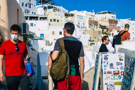 Santorini, Oia, Greece - October 24, 2021 Crowd of tourists visiting the famous perched town of Oia during the coronavirus epidemic hitting Greece, wearing a mask in the street is not mandatoryのeditorial素材