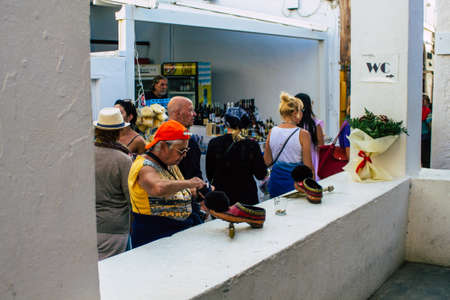 Santorini, Oia, Greece - October 24, 2021 Crowd of tourists visiting the famous perched town of Oia...