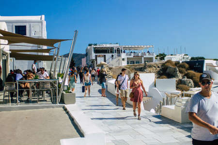Santorini, Oia, Greece - October 24, 2021 Crowd of tourists visiting the famous perched town of Oia during the coronavirus epidemic hitting Greece, wearing a mask in the street is not mandatoryのeditorial素材