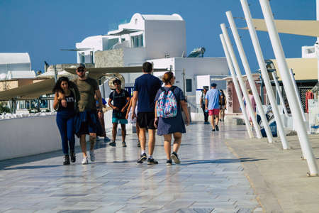 Santorini, Oia, Greece - October 24, 2021 Crowd of tourists visiting the famous perched town of Oia during the coronavirus epidemic hitting Greece, wearing a mask in the street is not mandatoryのeditorial素材