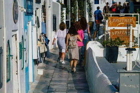 Santorini, Oia, Greece - October 24, 2021 Crowd of tourists visiting the famous perched town of Oia...