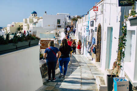 Santorini, Oia, Greece - October 24, 2021 Crowd of tourists visiting the famous perched town of Oia...