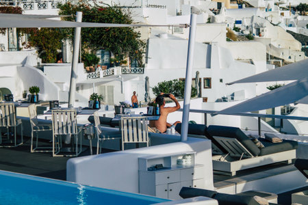 Santorini, Oia, Greece - October 24, 2021 Crowd of tourists visiting the famous perched town of Oia during the coronavirus epidemic hitting Greece, wearing a mask in the street is not mandatoryのeditorial素材