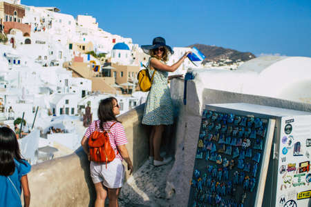 Santorini, Oia, Greece - October 24, 2021 Crowd of tourists visiting the famous perched town of Oia during the coronavirus epidemic hitting Greece, wearing a mask in the street is not mandatoryのeditorial素材