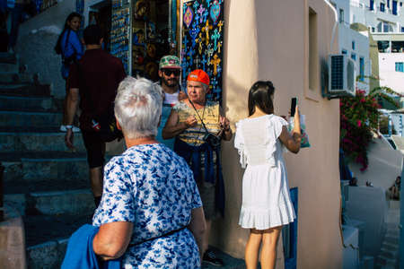 Santorini, Oia, Greece - October 24, 2021 Crowd of tourists visiting the famous perched town of Oia...