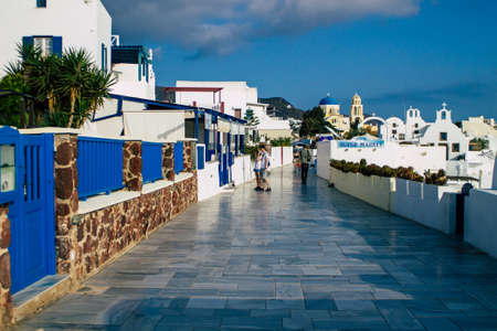 Santorini, Oia, Greece - October 24, 2021 Crowd of tourists visiting the famous perched town of Oia during the coronavirus epidemic hitting Greece, wearing a mask in the street is not mandatoryのeditorial素材