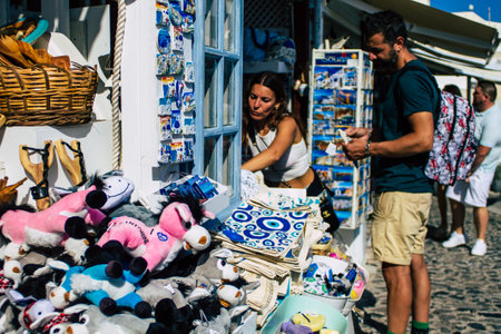 Santorini, Oia, Greece - October 24, 2021 Crowd of tourists visiting the famous perched town of Oia during the coronavirus epidemic hitting Greece, wearing a mask in the street is not mandatoryのeditorial素材