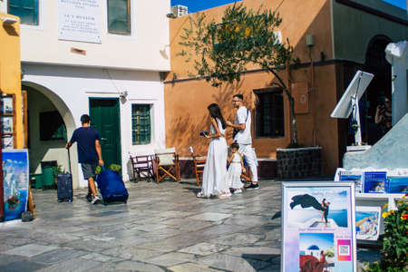 Santorini, Oia, Greece - October 24, 2021 Crowd of tourists visiting the famous perched town of Oia during the coronavirus epidemic hitting Greece, wearing a mask in the street is not mandatoryのeditorial素材