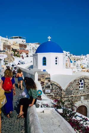 Santorini, Oia, Greece - October 24, 2021 Crowd of tourists visiting the famous perched town of Oia during the coronavirus epidemic hitting Greece, wearing a mask in the street is not mandatoryのeditorial素材
