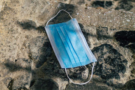 Santorini Island, Fira, Greece - October 27, 2021 Surgical mask to protect against the coronavirus thrown in the streets of Fira during the coronavirus pandemic affecting Greeceのeditorial素材