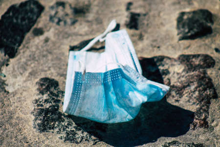 Santorini Island, Fira, Greece - October 27, 2021 Surgical mask to protect against the coronavirus thrown in the streets of Fira during the coronavirus pandemic affecting Greeceのeditorial素材