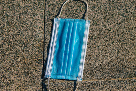 Santorini Island, Fira, Greece - October 27, 2021 Surgical mask to protect against the coronavirus thrown in the streets of Fira during the coronavirus pandemic affecting Greeceのeditorial素材