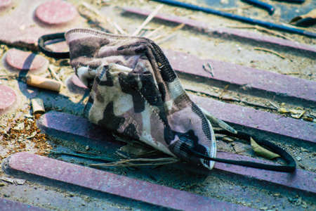 Santorini Island, Fira, Greece - October 27, 2021 Surgical mask to protect against the coronavirus thrown in the streets of Fira during the coronavirus pandemic affecting Greeceのeditorial素材