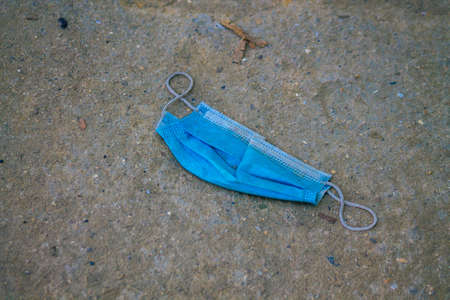Santorini Island, Fira, Greece - October 27, 2021 Surgical mask to protect against the coronavirus thrown in the streets of Fira during the coronavirus pandemic affecting Greeceのeditorial素材
