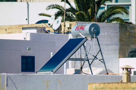 Santorini, Greece - October 28, 2021 Solar water heating on a roof of a building in Santorini, Solar water heating is heating water by sunlight using a solar thermal collectorのeditorial素材