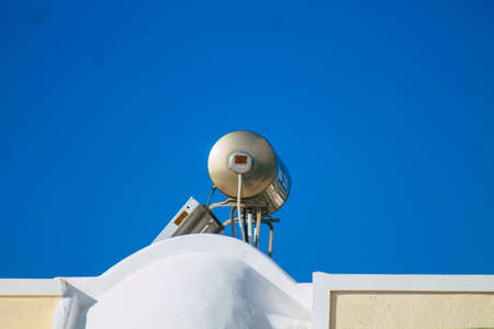 Santorini, Greece - October 28, 2021 Solar water heating on a roof of a building in Santorini, Solar water heating is heating water by sunlight using a solar thermal collectorのeditorial素材
