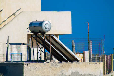 Santorini, Greece - October 28, 2021 Solar water heating on a roof of a building in Santorini, Solar...