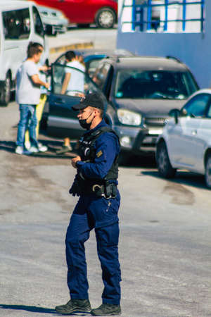 Santorini, Greece - October 28, 2021 Police in the port of Santorini, one of the missions is to control the departure and arrival of ferry passengersのeditorial素材
