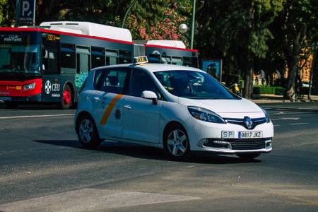 Seville Spain August 11, 2021 Taxi driving through the streets of Seville during the coronavirus outbreak hitting Spain, wearing a mask is mandatoryのeditorial素材
