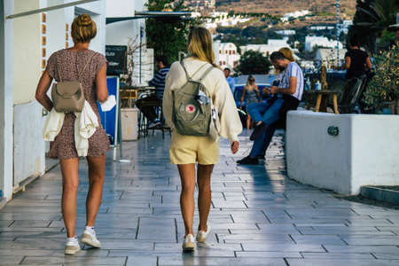 Santorini, Oia, Greece - October 18, 2021 Crowd of tourists visiting the famous perched town of Oia during the coronavirus epidemic hitting Greece, wearing a mask in the street is not mandatoryのeditorial素材