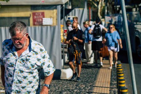 Santorini, Fira, Greece - October 20, 2021 Crowd of tourists at the bus station, all the buses...