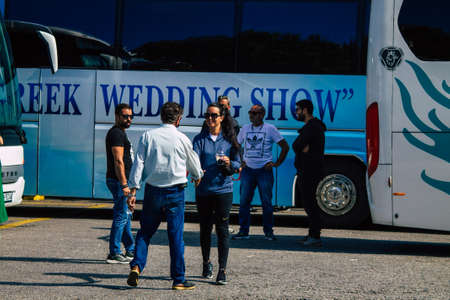 Santorini, Fira, Greece - October 20, 2021 Crowd of tourists at the bus station, all the buses...