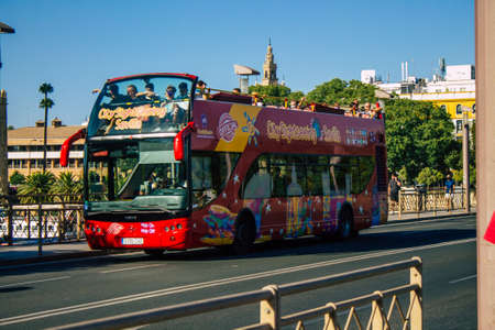 Seville Spain August 11, 2021 Tourist bus driving through the streets of Seville during the...
