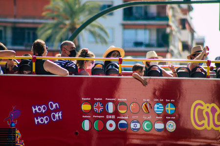 Seville Spain August 11, 2021 Tourist bus driving through the streets of Seville during the coronavirus outbreak hitting Spain, wearing a mask is mandatoryのeditorial素材