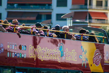 Seville Spain August 11, 2021 Tourist bus driving through the streets of Seville during the coronavirus outbreak hitting Spain, wearing a mask is mandatoryのeditorial素材