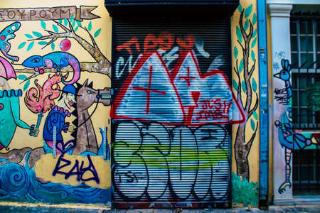 Athens, Greece - November 22, 2021 Street art in Athens, graffiti that covers the whole city, where every alley, shop front, brick wallis an artistic canvas, of political reference or of social satireの写真素材